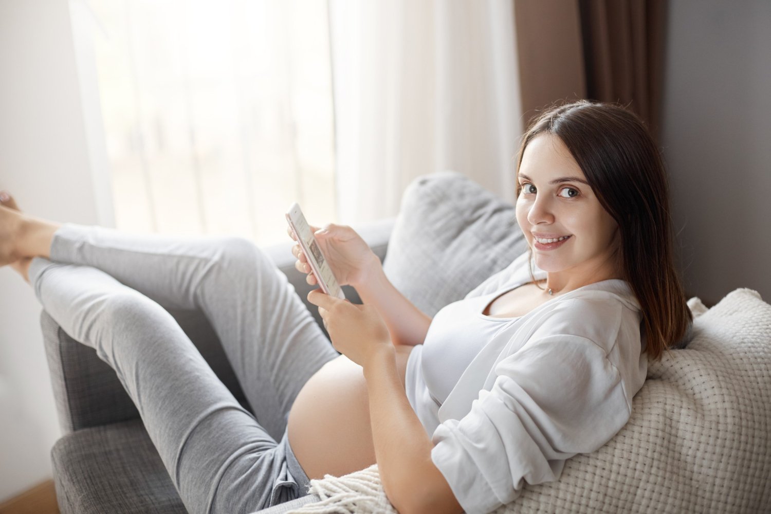 A beautifully lit close-up portrait of two young, radiant pregnant women with glowing, healthy skin. They are surrounded by an artfully arranged display of natural skincare ingredients such as chamomile flowers, aloe vera leaves, and oatmeal. The women's soft, warm expressions convey a sense of serene confidence. The lighting is soft and diffused, creating a luminous, ethereal atmosphere. The overall scene exudes a calming, nurturing vibe, perfectly capturing the benefits of using natural, pregnancy-safe skincare products.